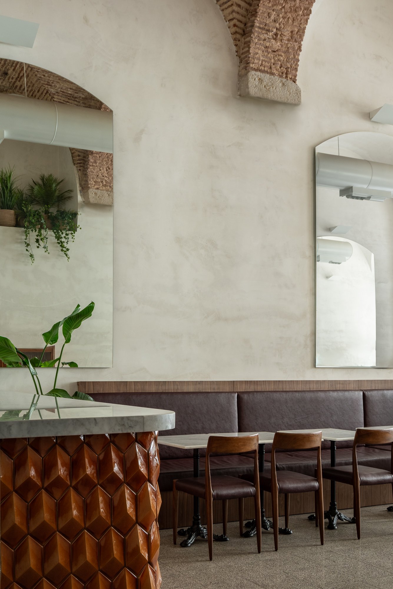 Detail of dining area with sculptural textured table base