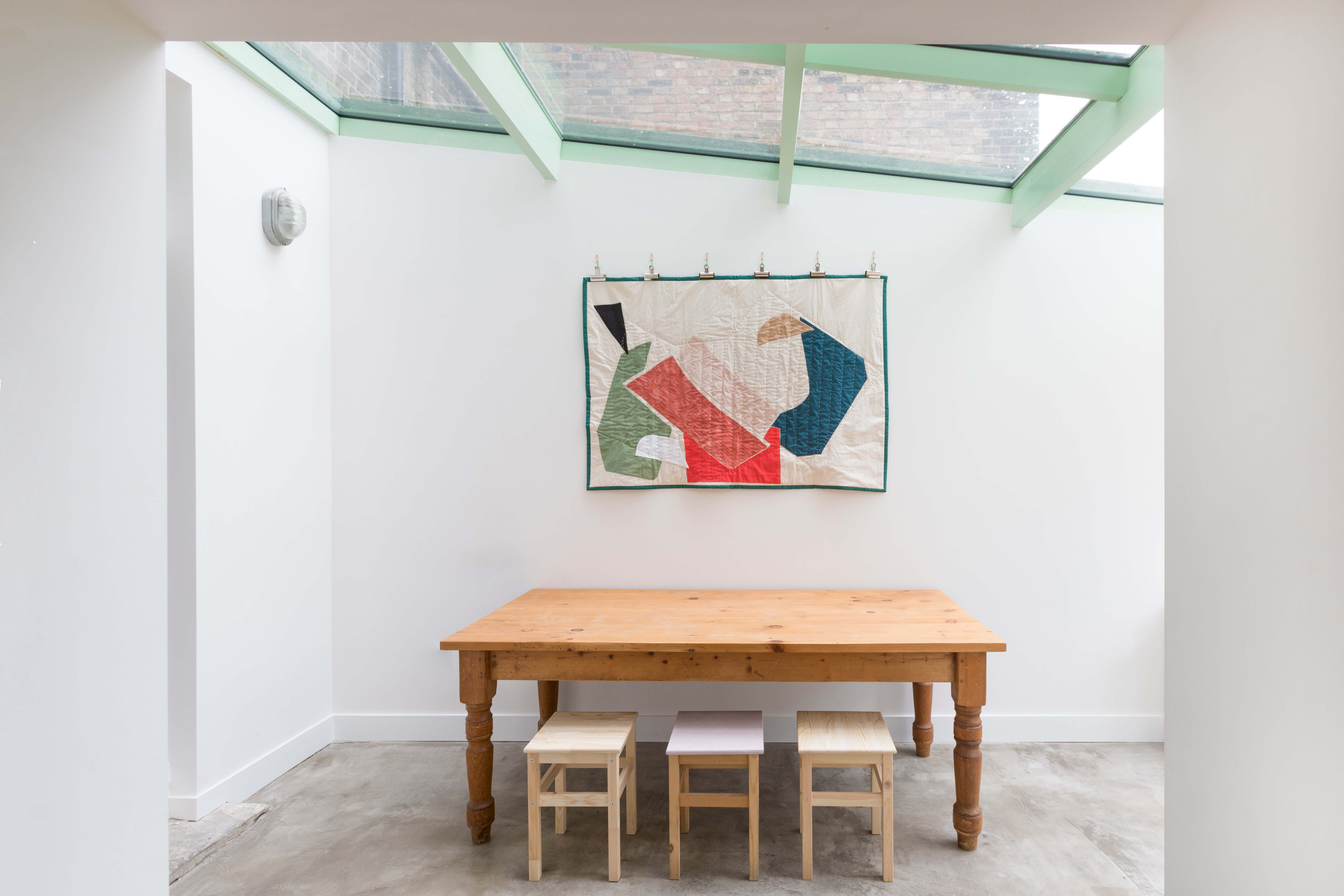 Minimalist dining area under glass roof